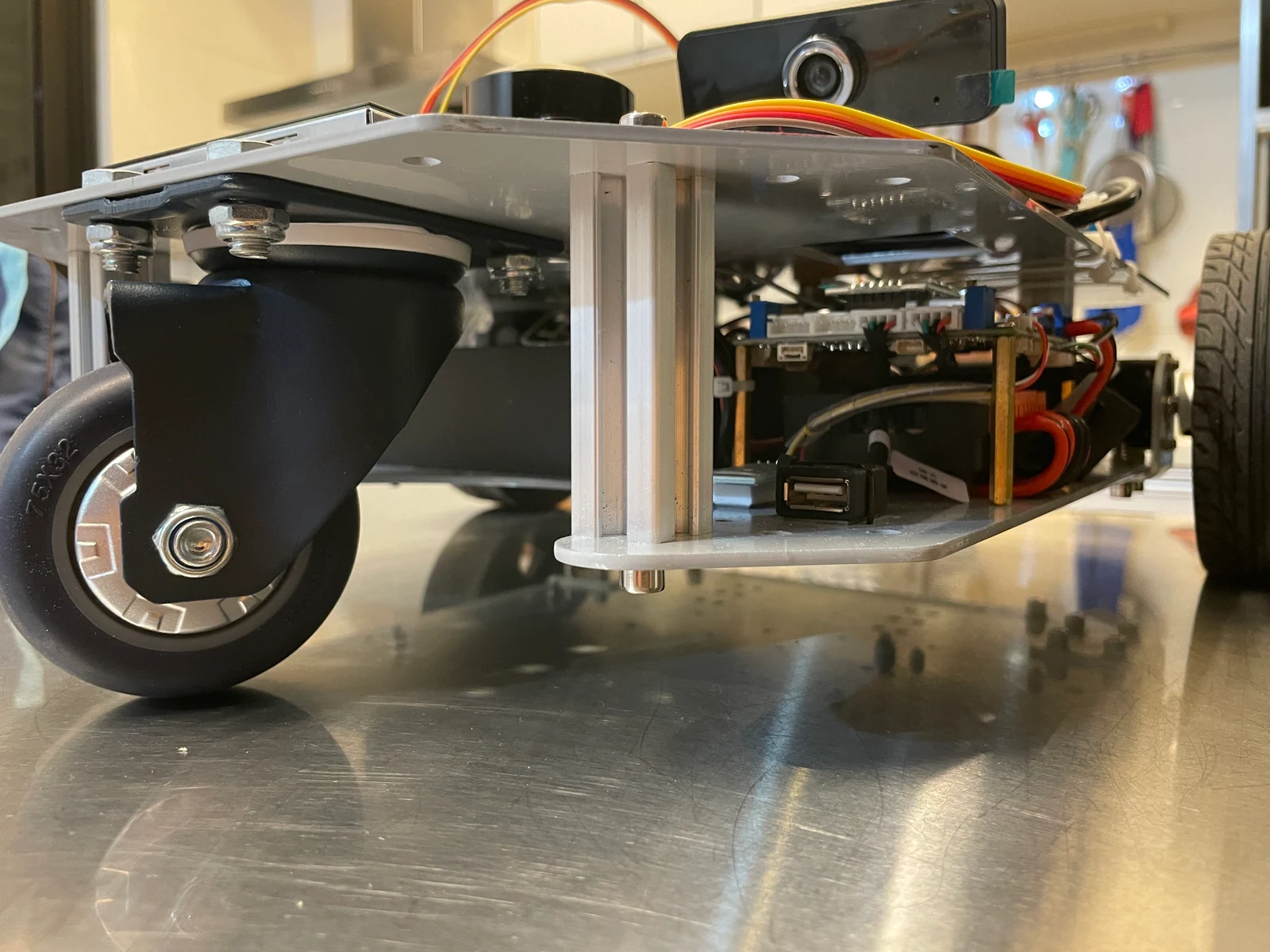 Low-angle view of the robot chassis, front caster and lower electronics