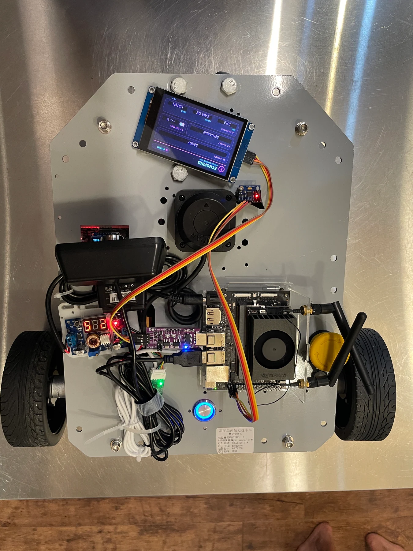 Top view of the powered robot with controller wiring, compute board and display