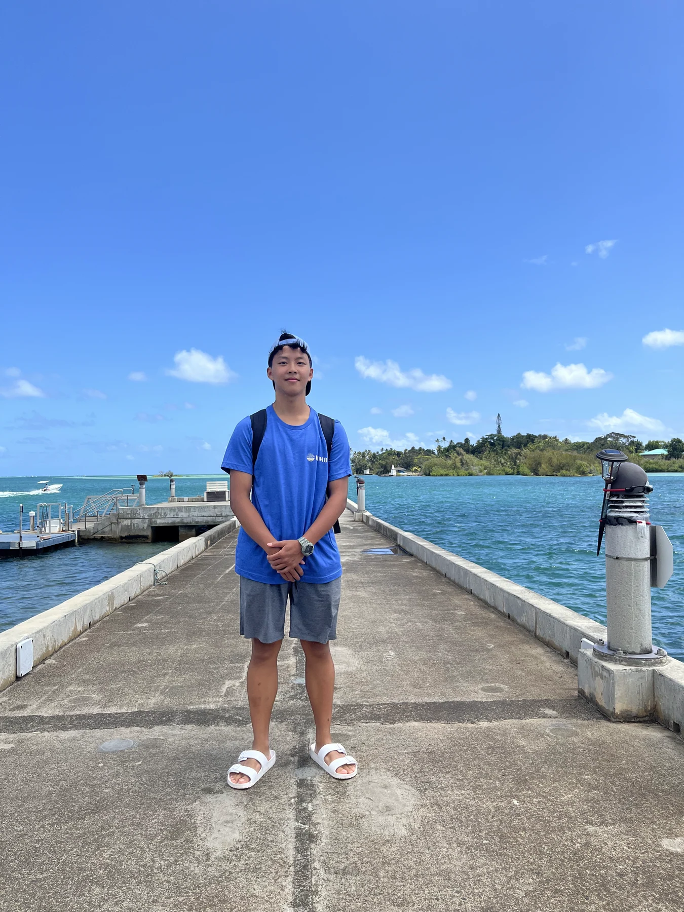 Benjamin standing outdoors beside the water at HIMB
