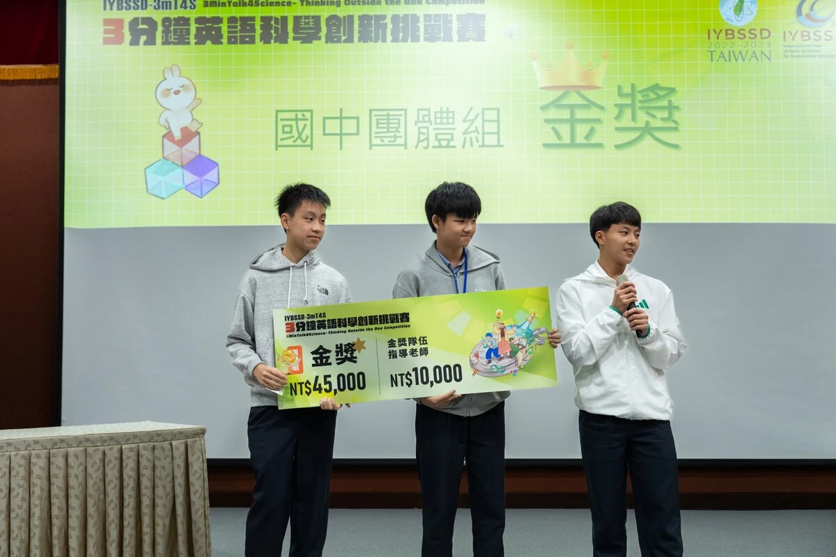Benjamin speaking with his teammates after their science competition award