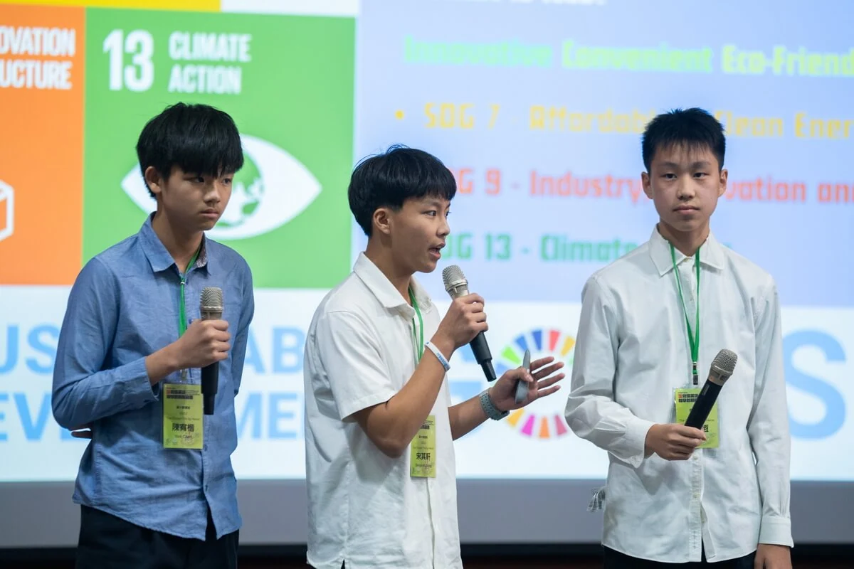 Benjamin and teammates answering questions during the science competition