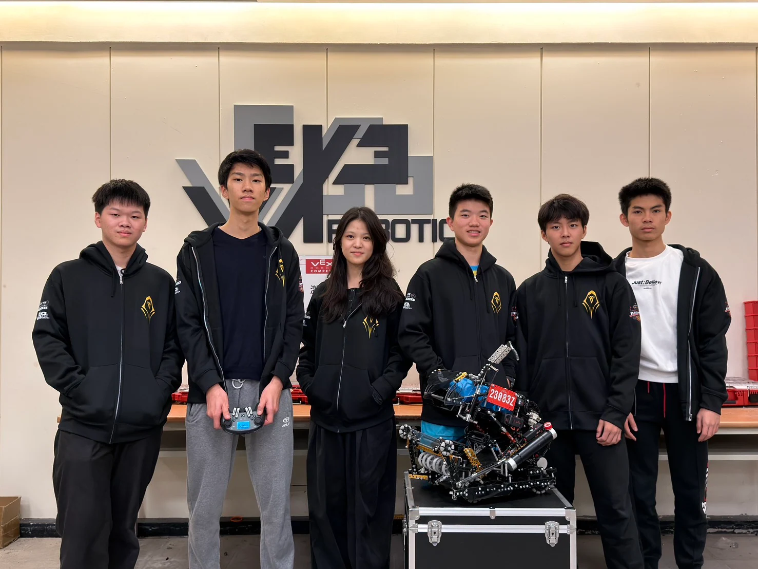 Wego Robotics teammates standing with their team-built robot