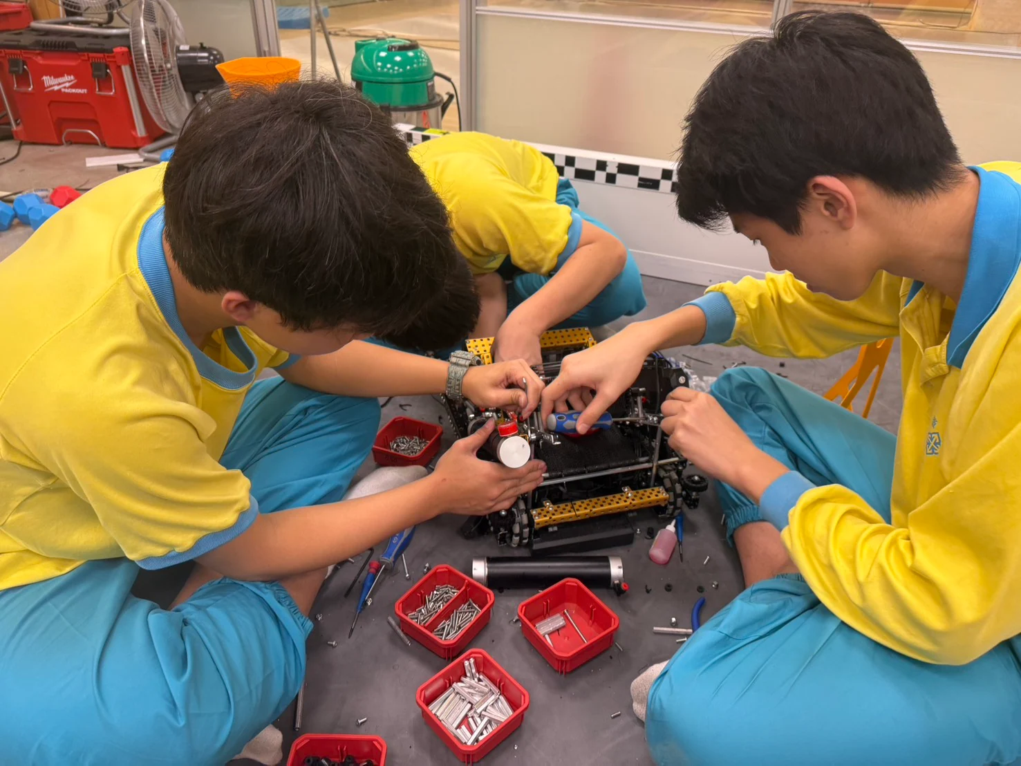 Benjamin and teammates working together on a robot mechanism